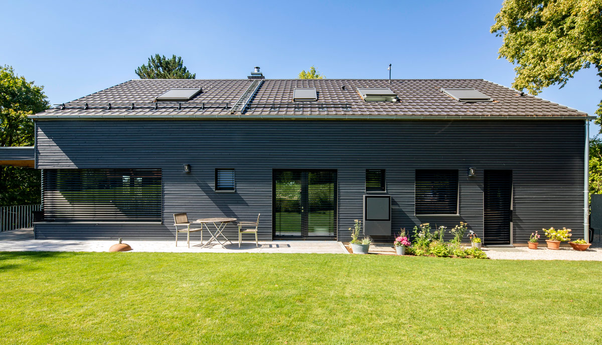Ein modernes Holzhaus in Glonn mit gepflegtem Garten und Terrasse lädt zum Entspannen im Freien ein.