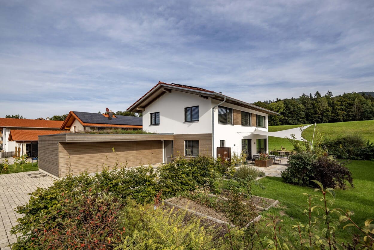 teilverputztes Holzhaus mit Carport, Gartenansicht